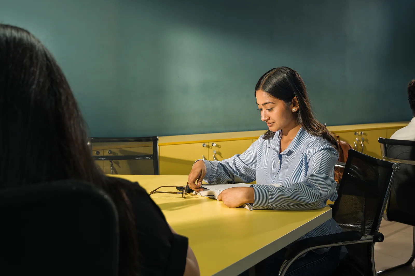 Techspire student reading and studying at a campus table