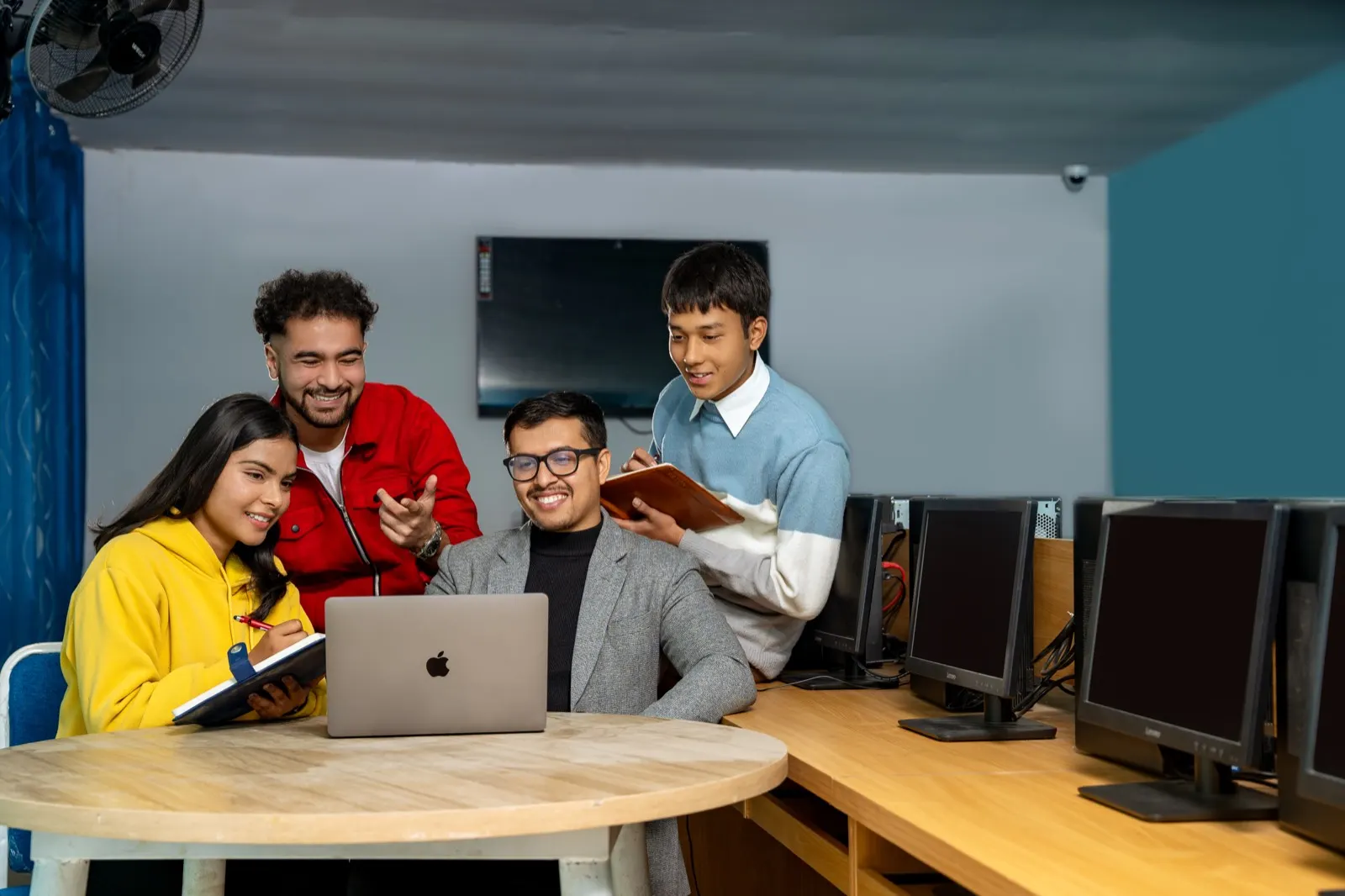 Students with a mentor in a computer lab